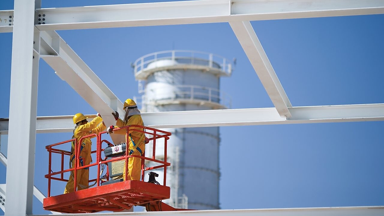 Two engineers on crane doing maintenance work
