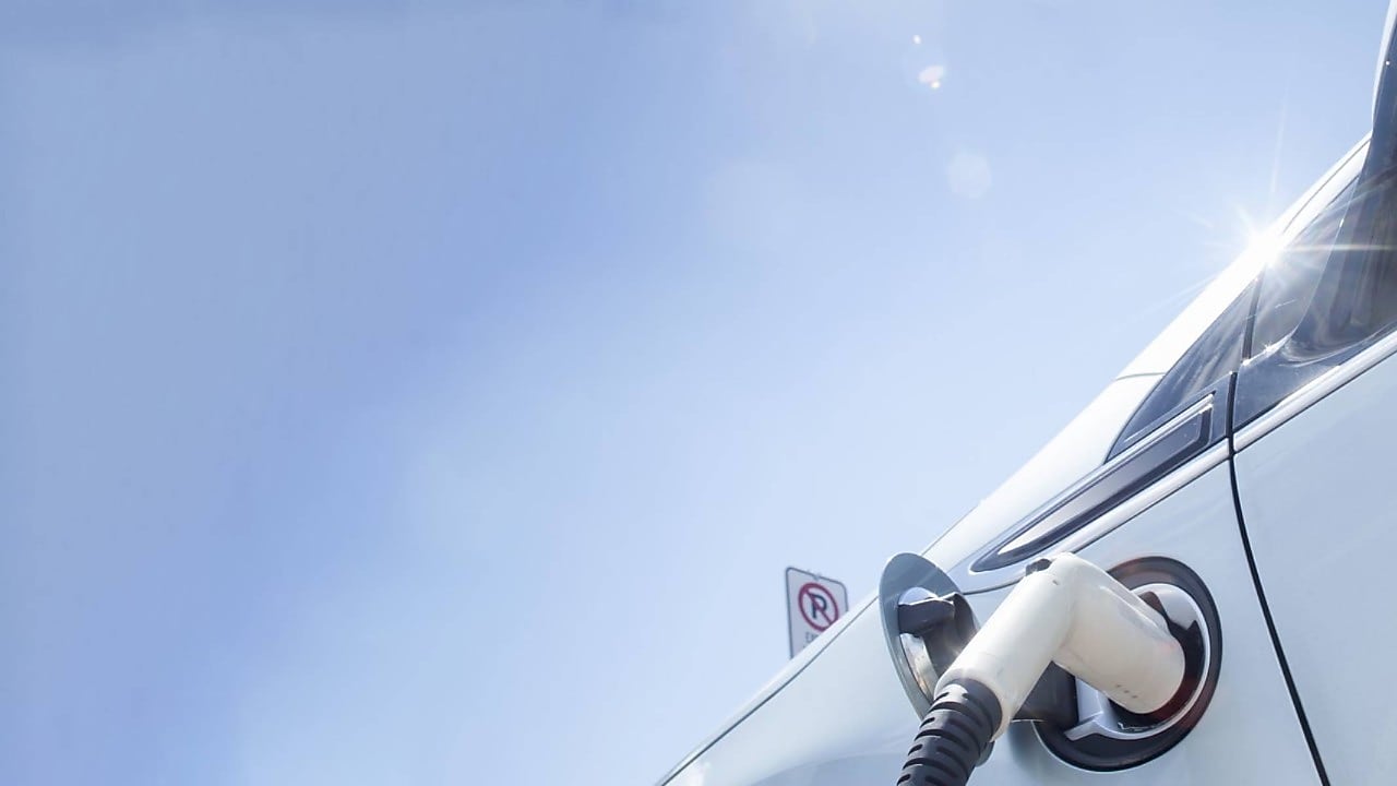 A fuel pump in the tank of a car under a blue sky